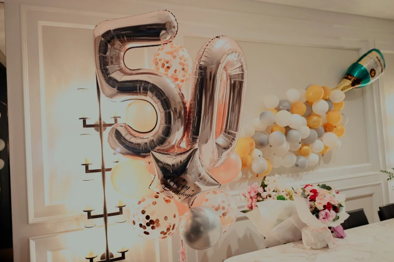 balloons and flowers are arranged in the corner of this room