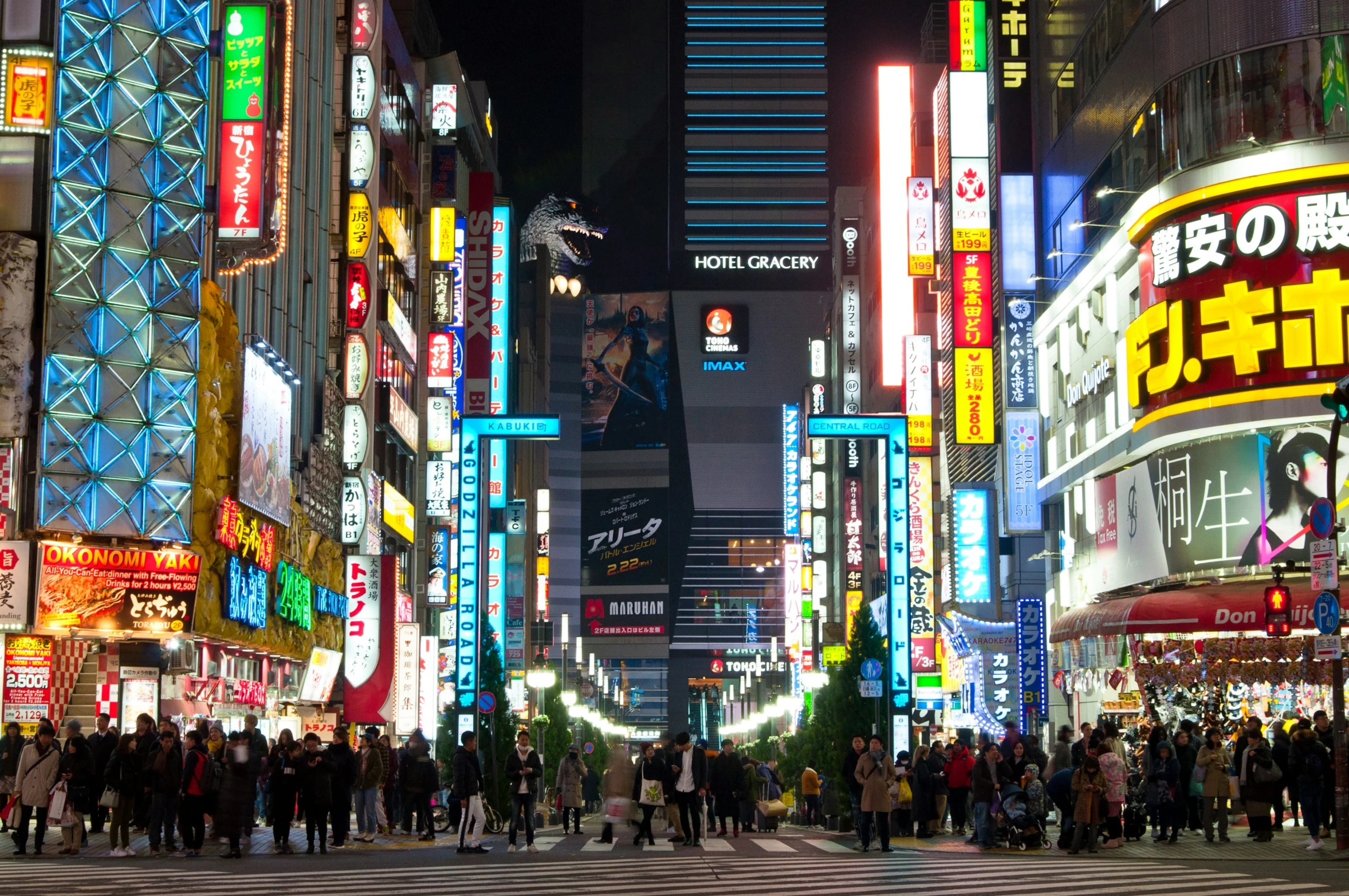 this is a busy city street with many neon lights