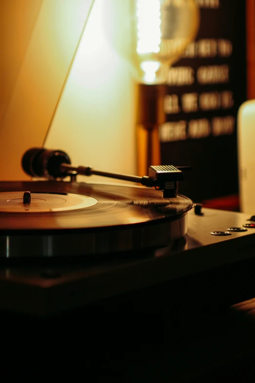 a record player is next to a microphone and some speakers