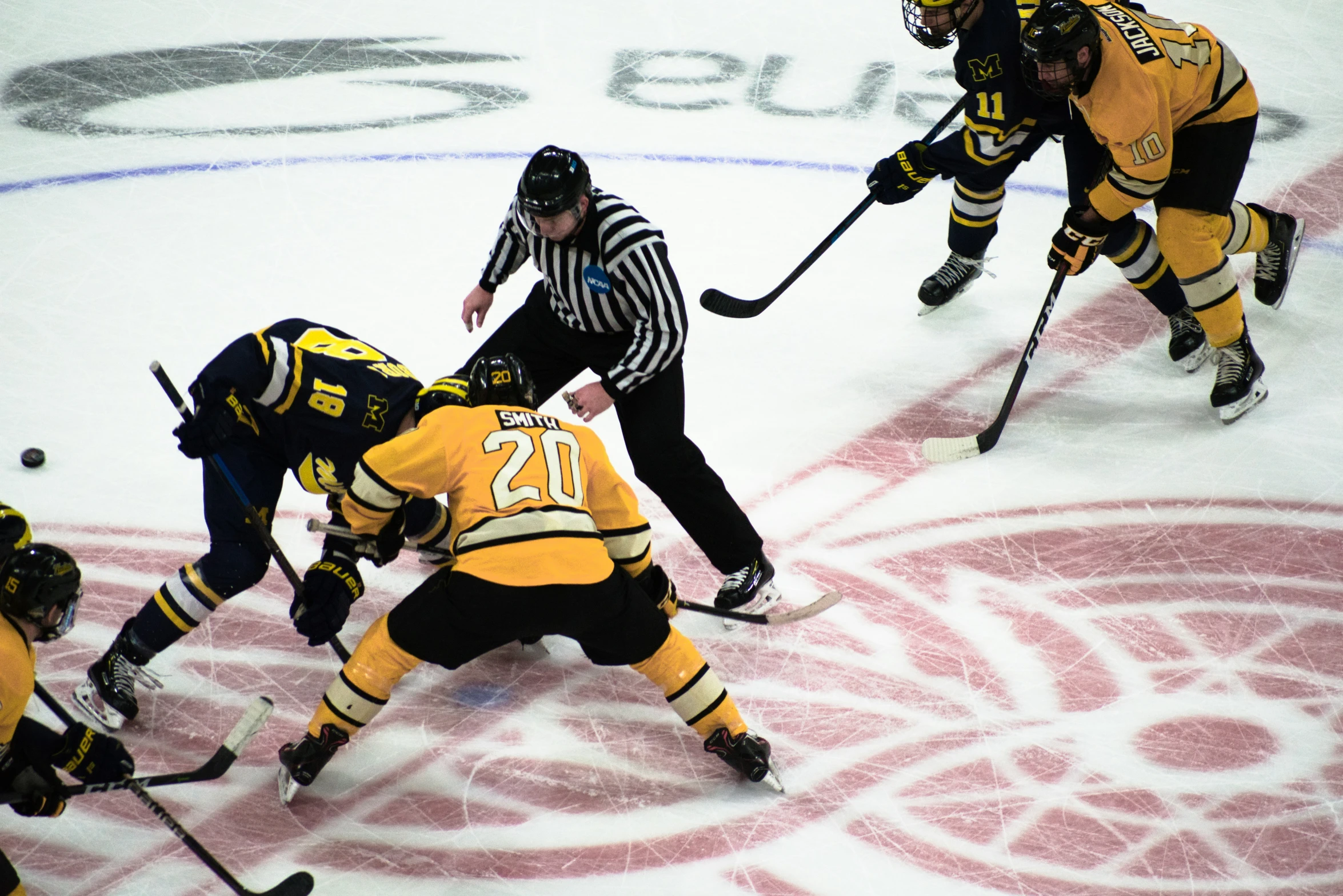 some people are playing ice hockey on the rink