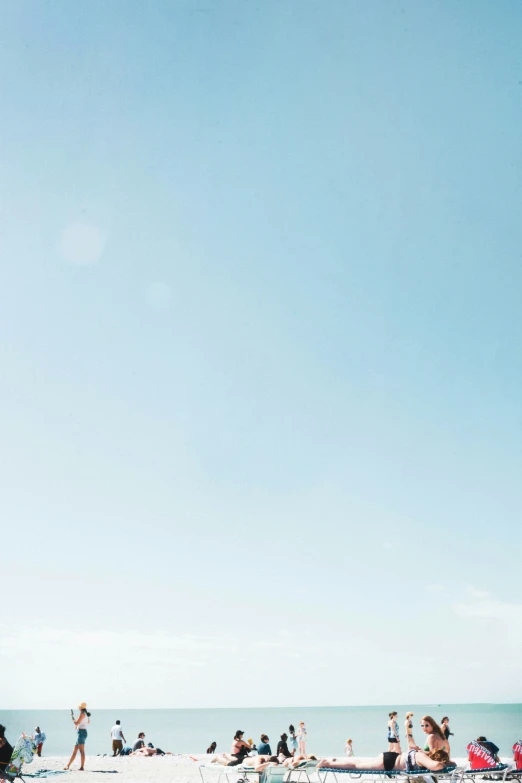 people are sitting at the beach on a clear day