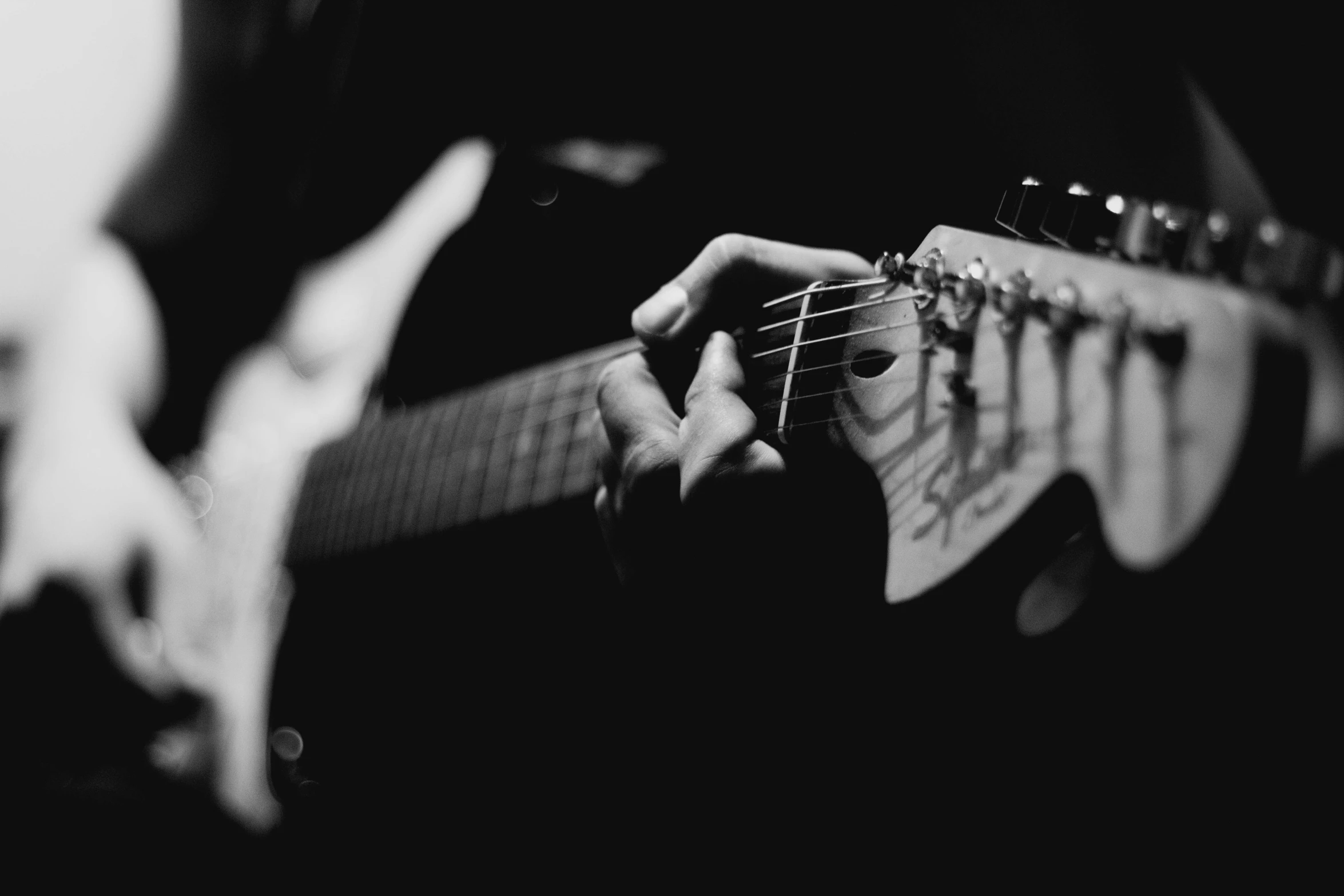 someone is playing an electric guitar indoors