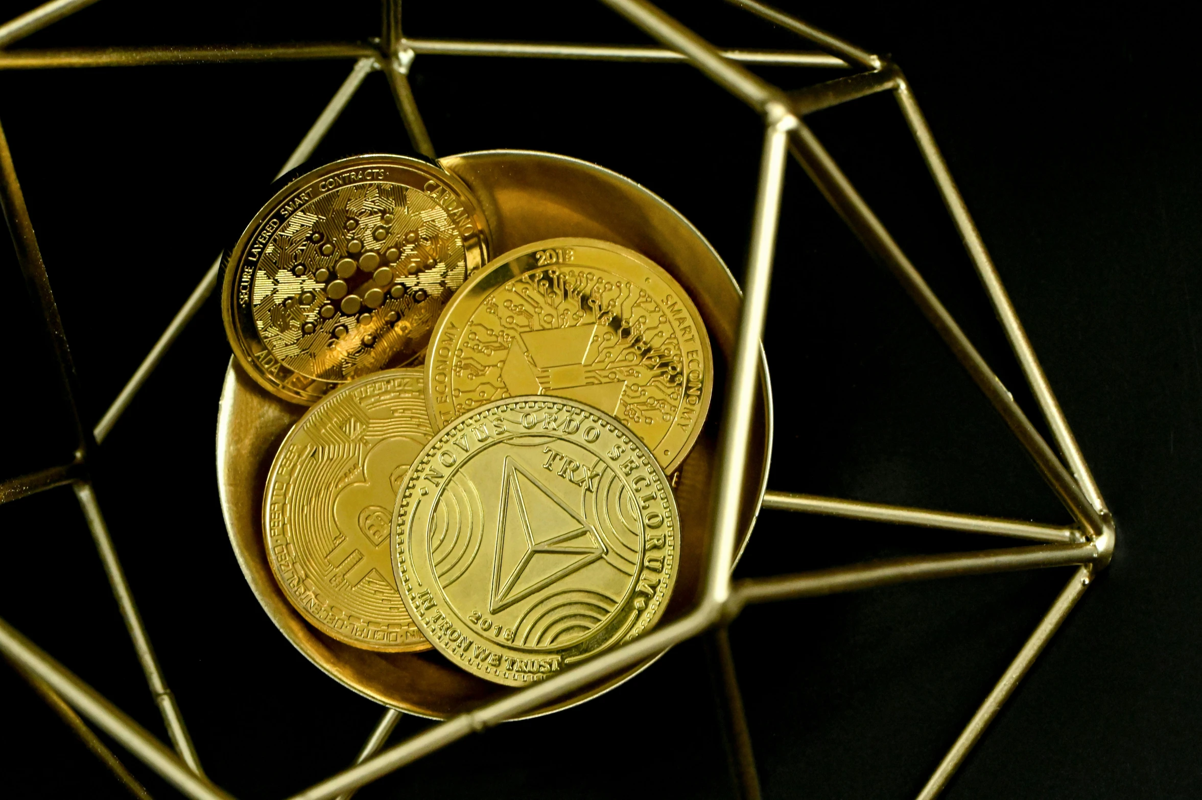 two gold coin pieces with gold numerals sitting on top of each other