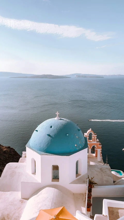 an umbrella on a roof over a sea