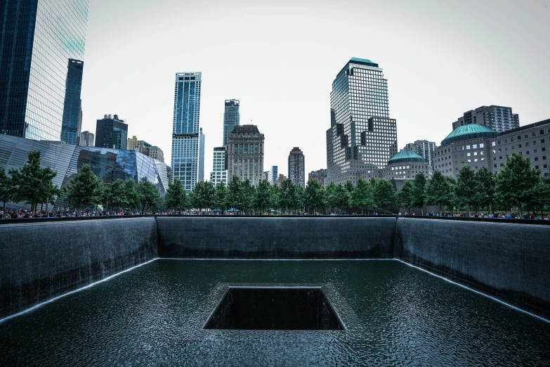 there is a water trough surrounded by buildings