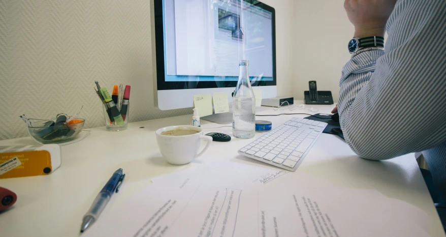 man using the computer while drinking coffee