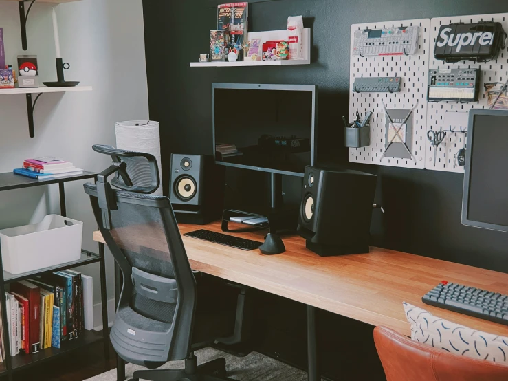 there is a desk with a computer and speakers on it