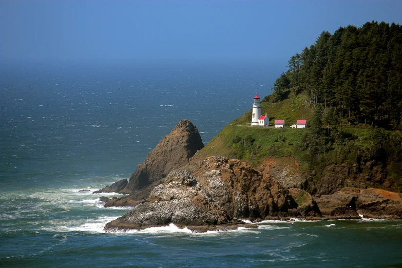 there is an island in the water and it is very near a lighthouse