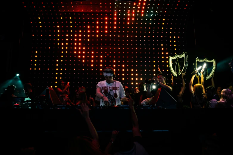 a man standing in front of a microphone with a crowd