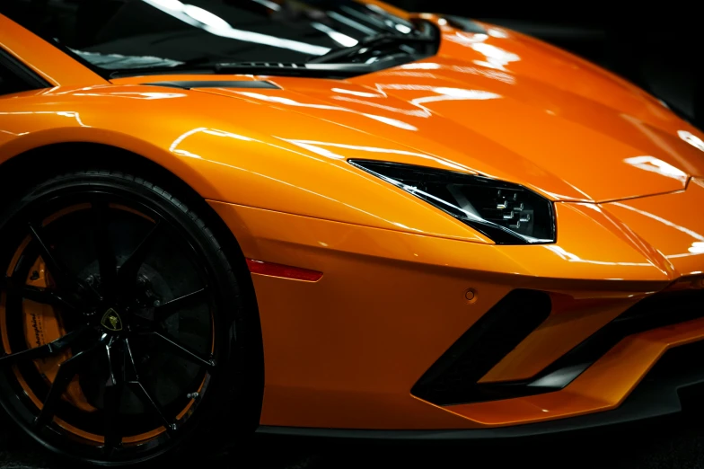 a close up s of an orange sports car
