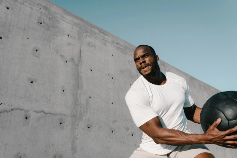 a man holding a basketball ball posing for the camera