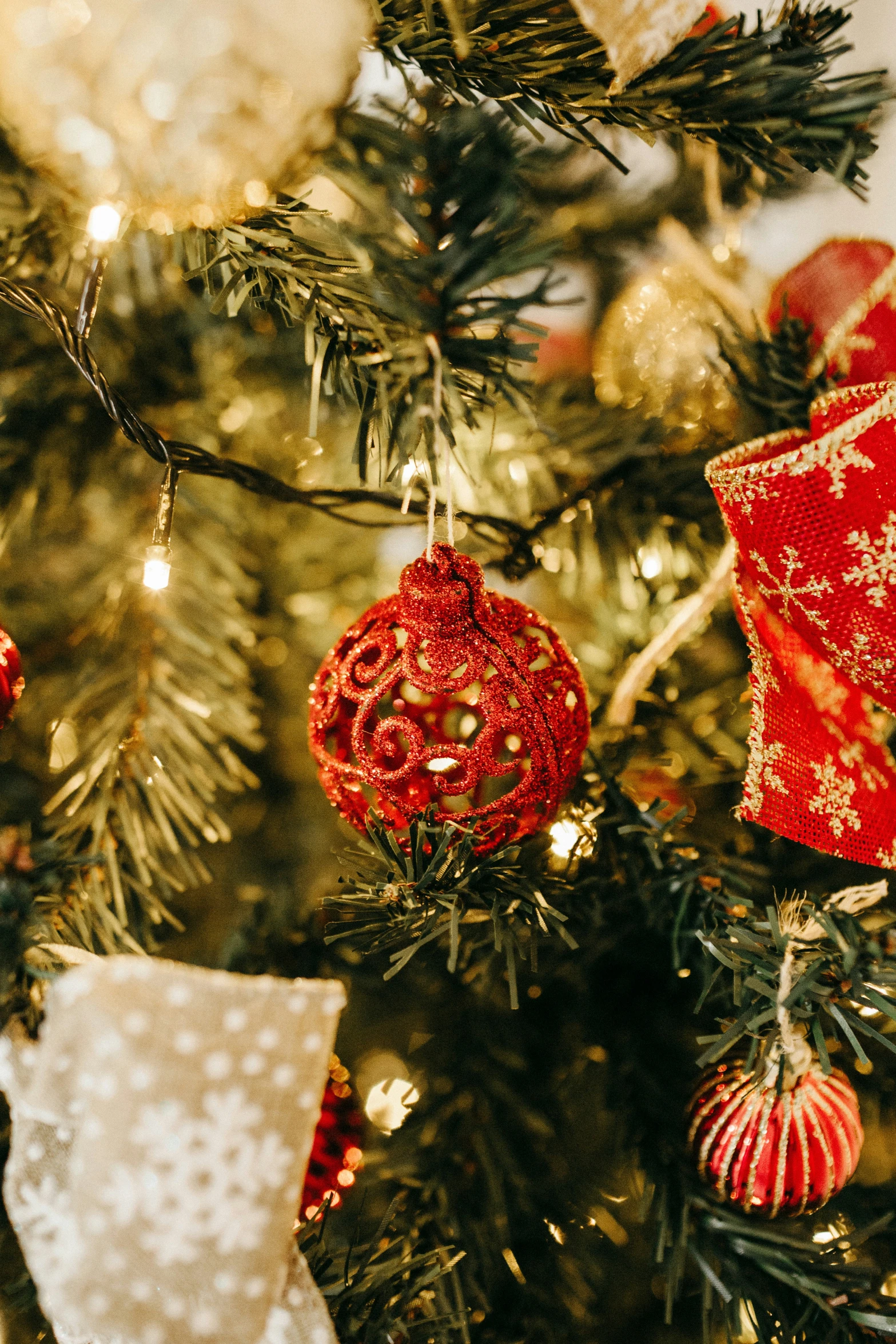 an assortment of ornaments hang on the top of a christmas tree