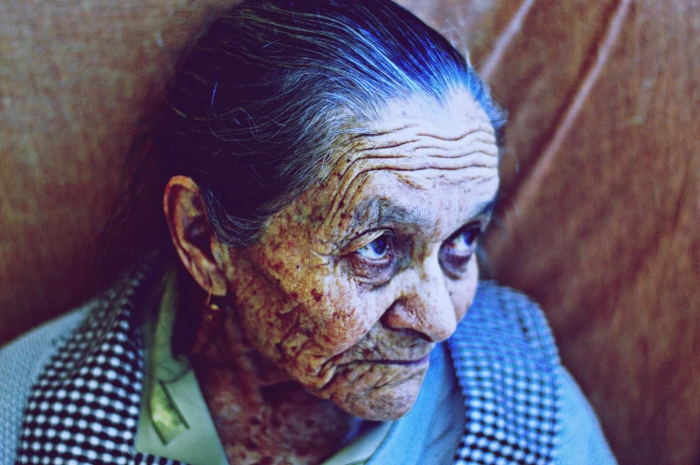 an older woman with black hair and old skin