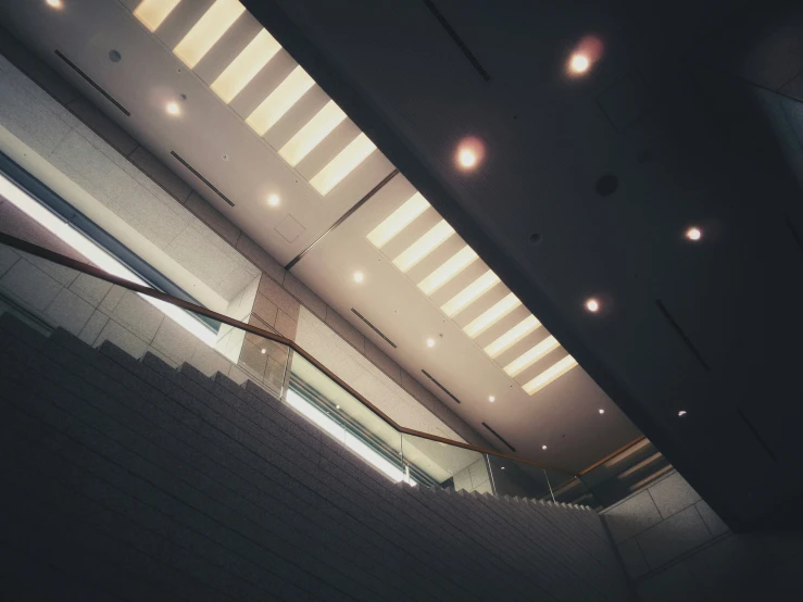 a long hallway with windows and lights at night