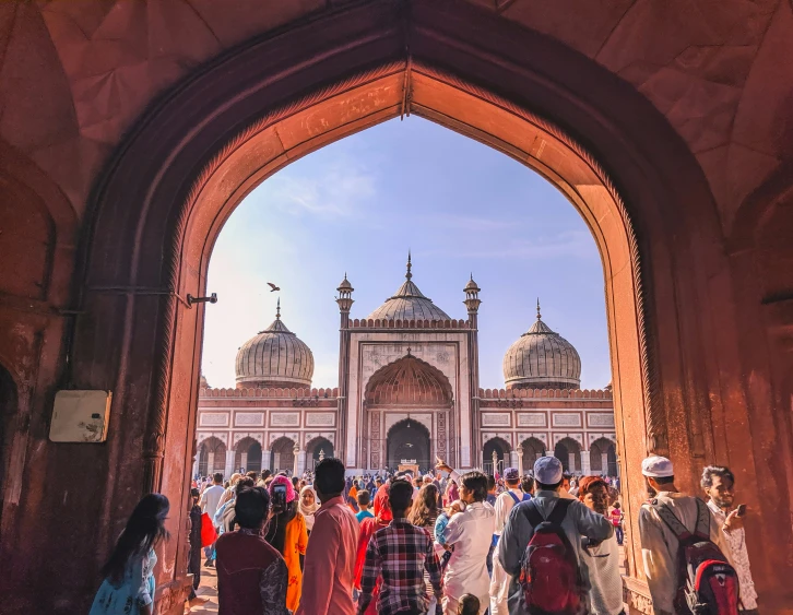 a group of people in front of the entrance to an oriental building