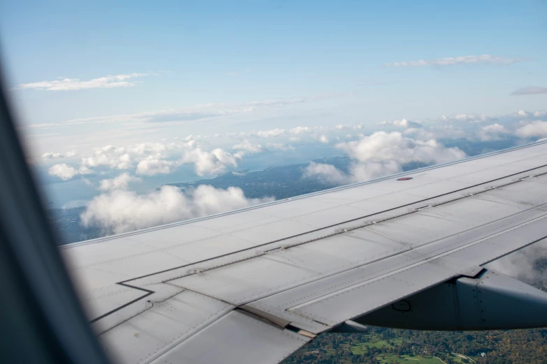 the view from the window of an airplane looking out over the clouds