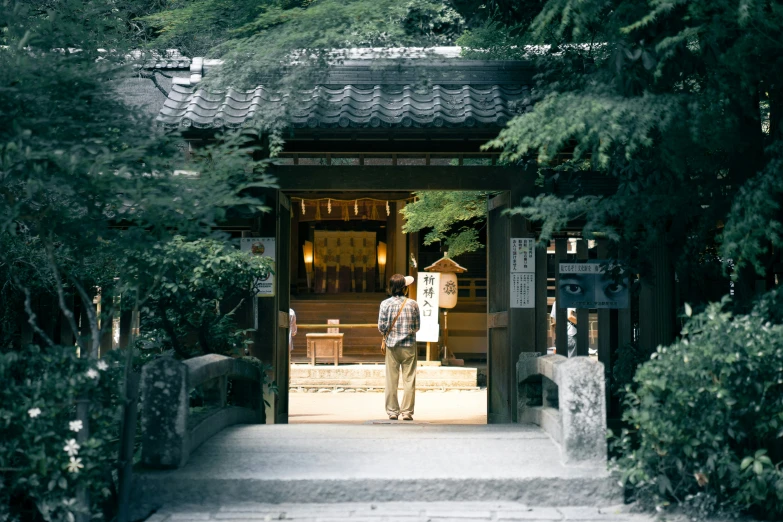 a man standing outside a doorway in the middle of some steps