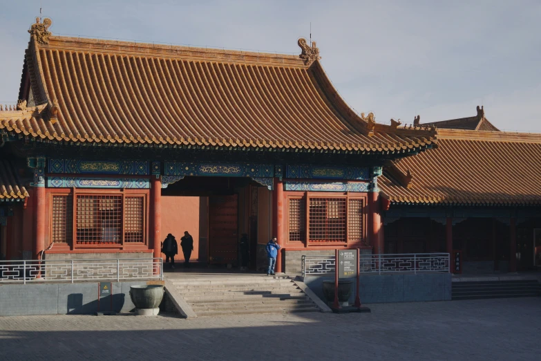 two men standing in front of a chinese style building