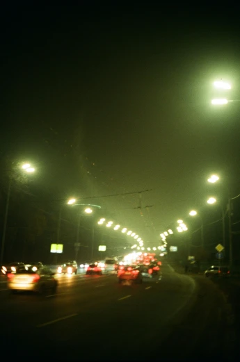 many cars at night driving down a city road