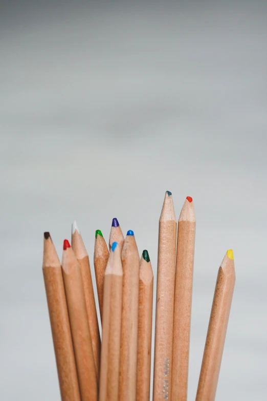 a bunch of pencils that have different colored ends