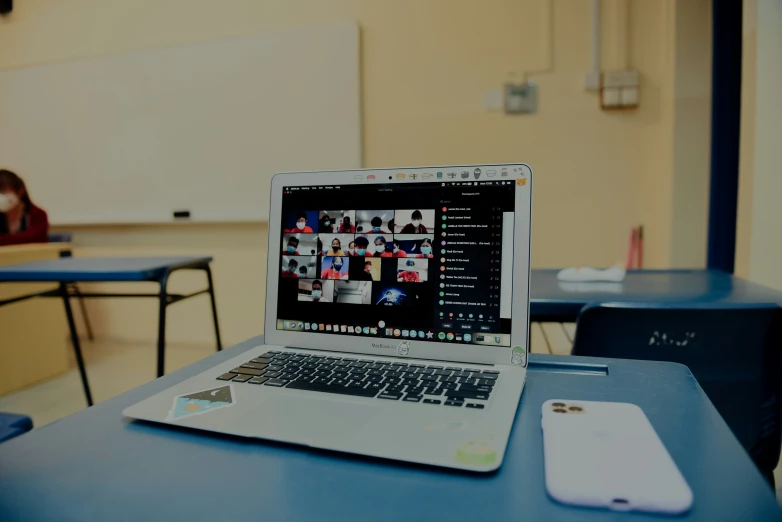 a laptop computer on top of a desk in an empty room