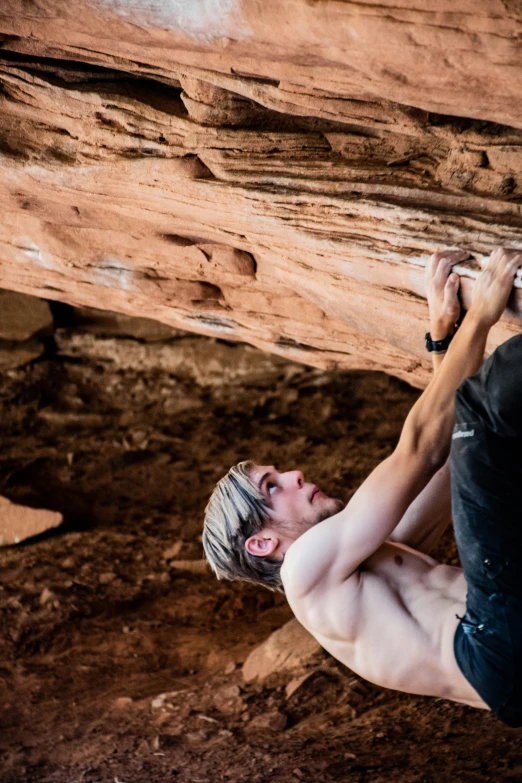 there is a man climbing up a rock