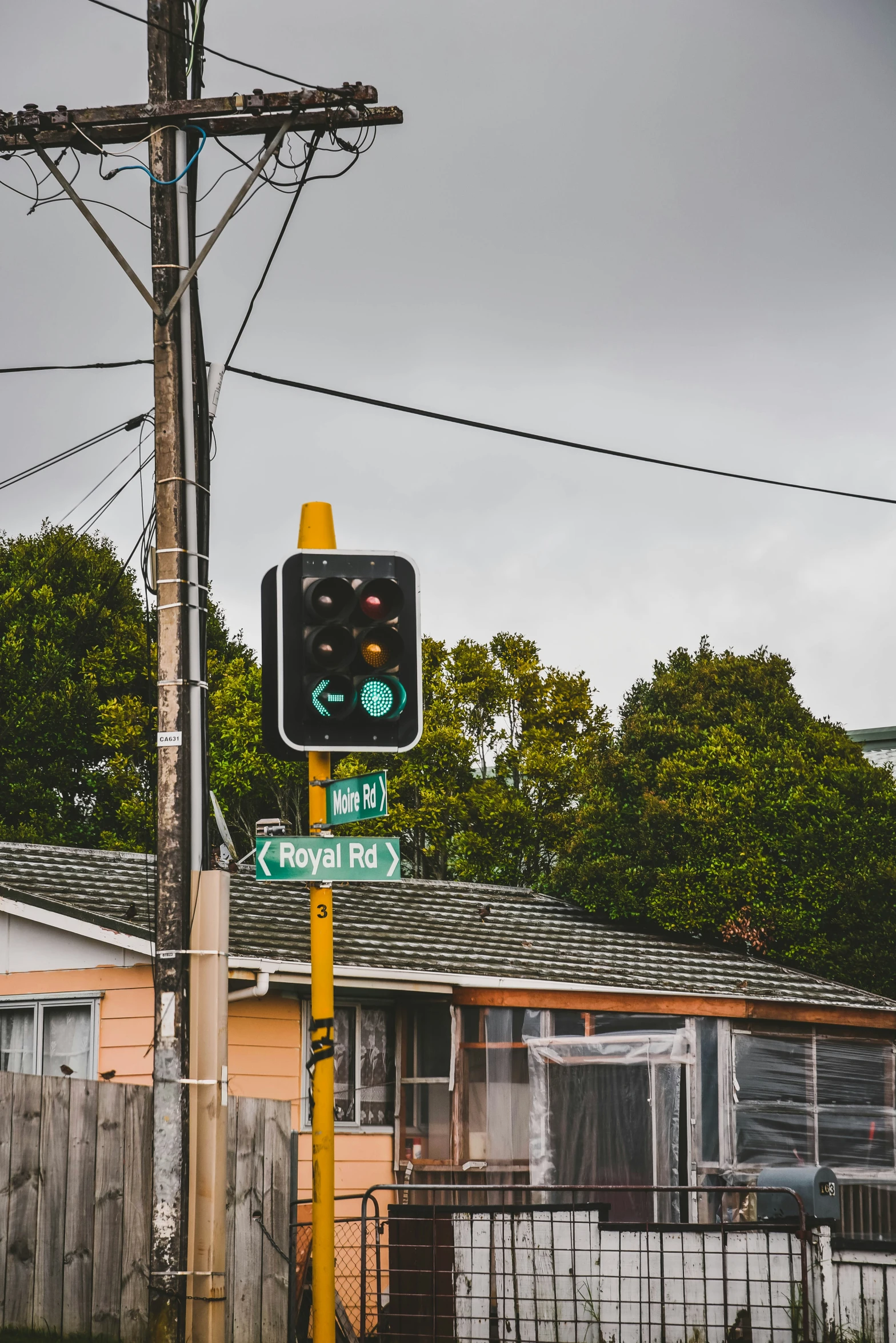 two street signs and a traffic light are on a pole