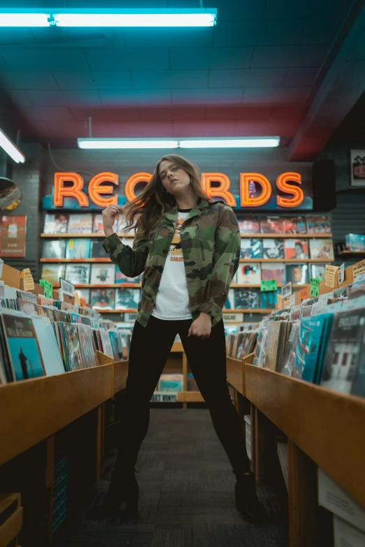a woman posing with her hand in her hair in a record store