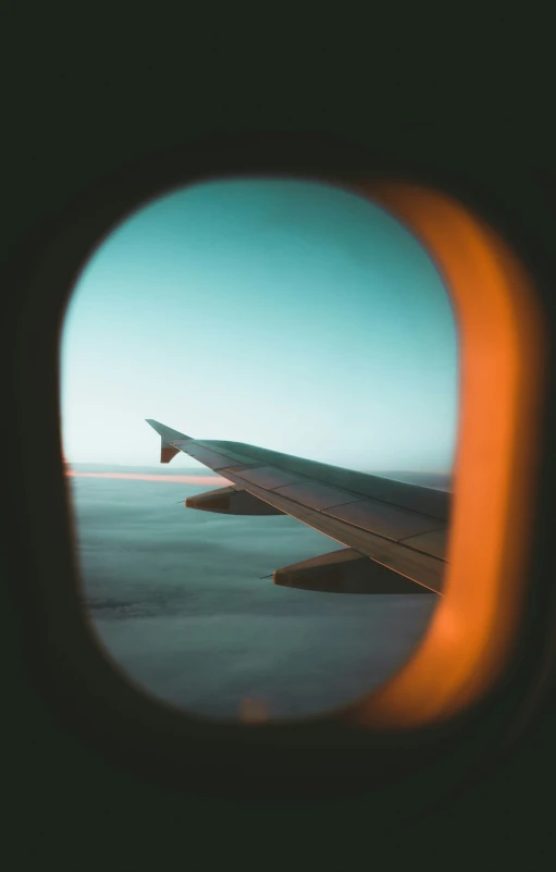 a wing looking out of a window into the sky