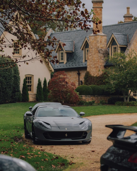 the front view of a luxury sports car parked on the driveway