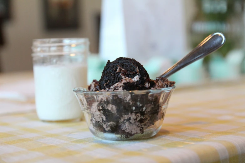 a desert is in a bowl next to a glass of milk