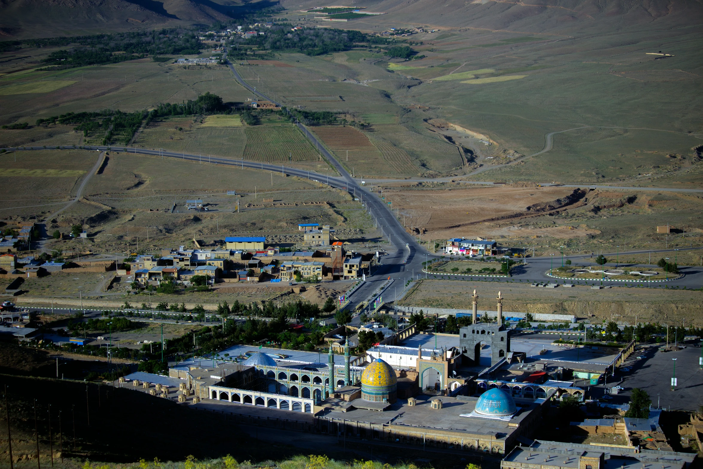 an aerial view of a town in the mountains