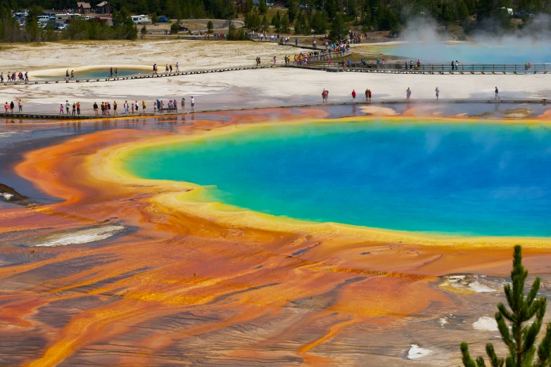 a large crater surrounded by several pools in a small town