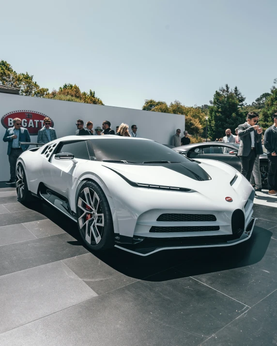 a bugatti car with people standing around looking at it