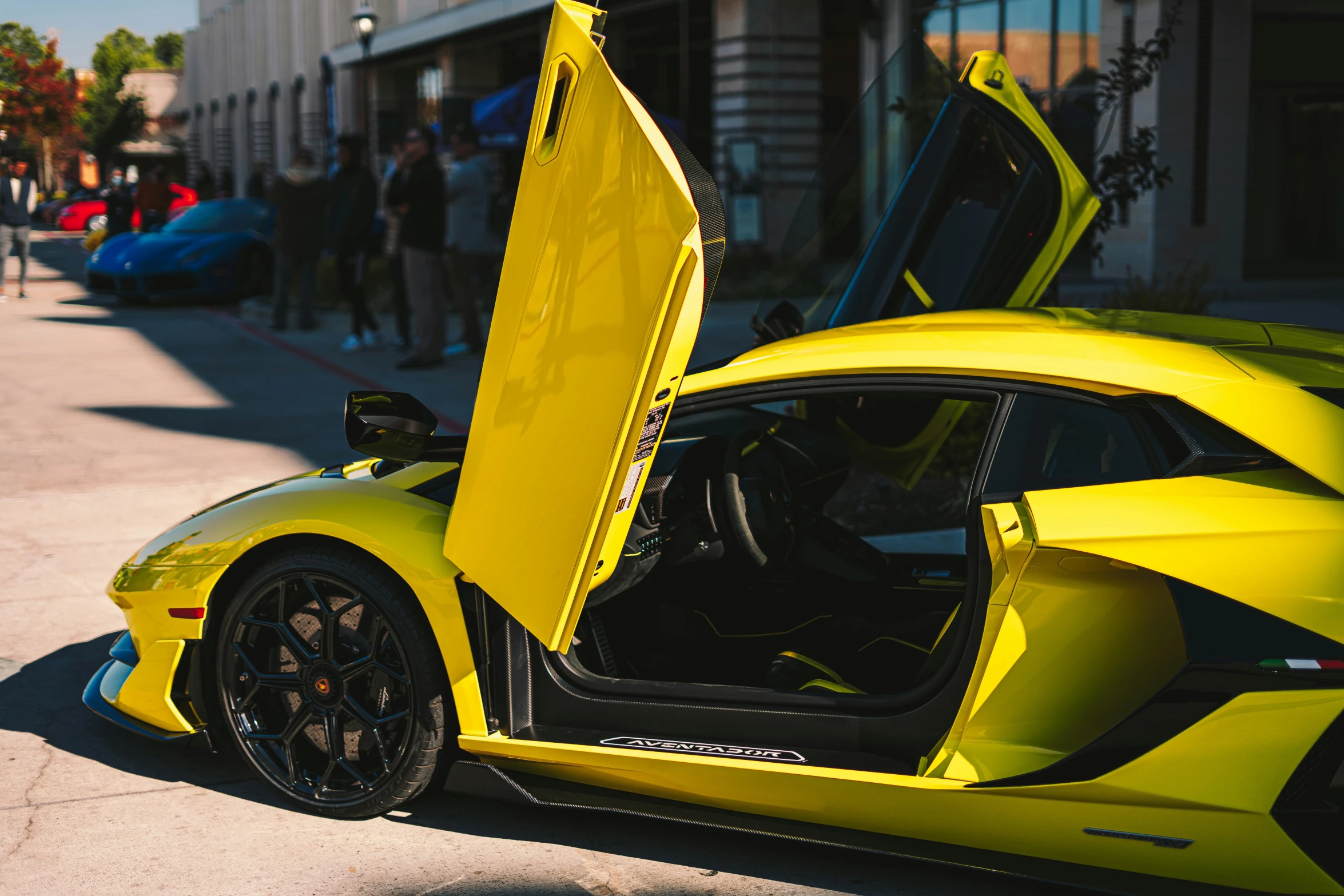 a yellow sports car is parked on the side of the street