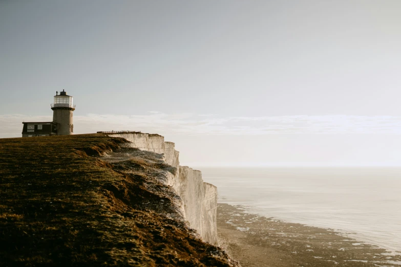 a tall stone cliff overlooking the water