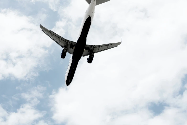 an airplane in the air against a blue cloudy sky