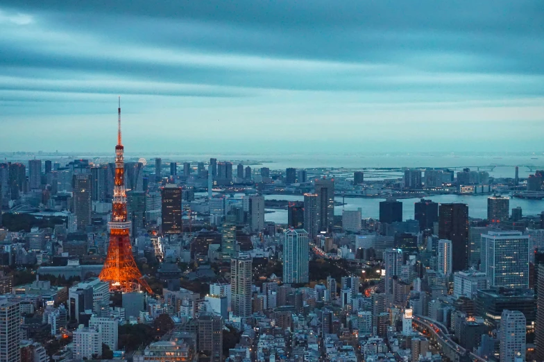 a city skyline at night with a bright lit tower