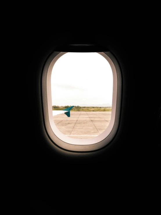 view out an airplane window of an airfield