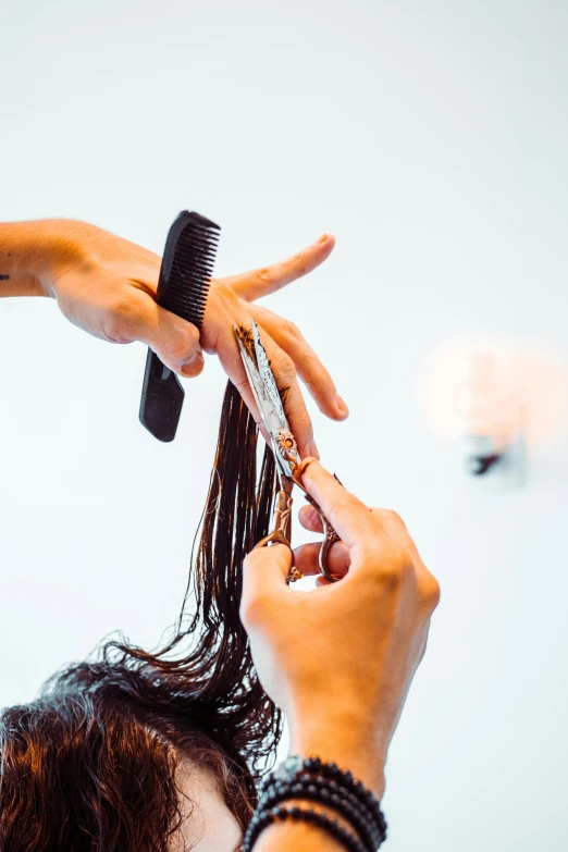 woman is  her hair with an item