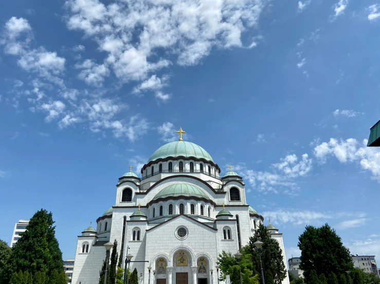 a church with a large dome under a blue sky