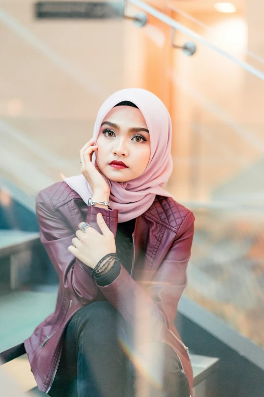 a woman in hijab standing on some stairs