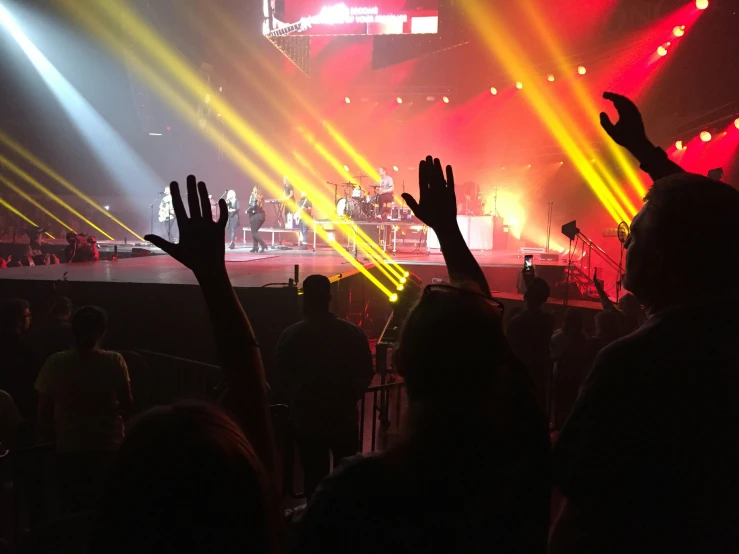 people in front of brightly colored lights at a concert