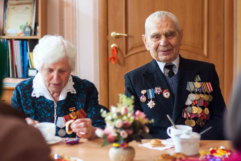 an older couple at a table in the office