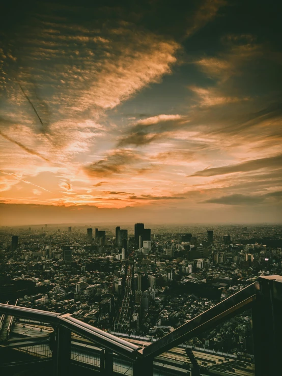 a city is pictured at sunset over a river