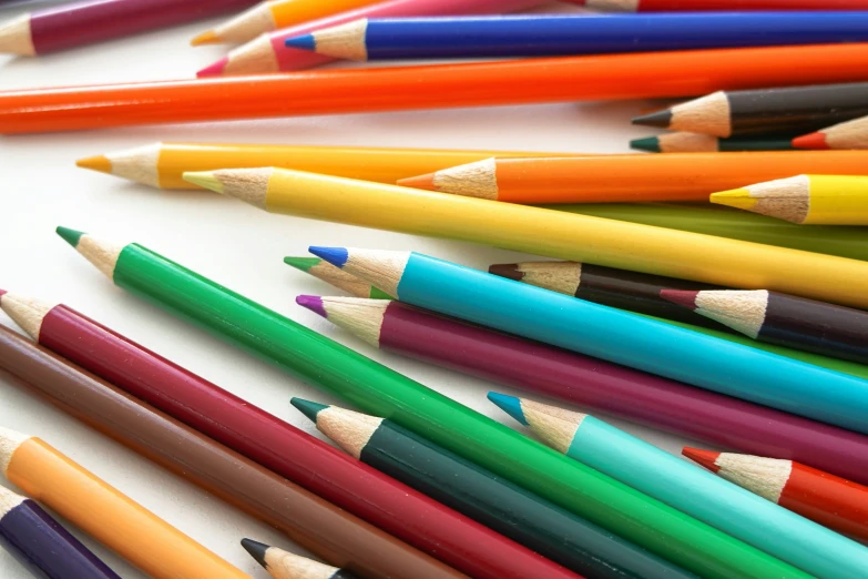 a variety of different colored pencils lined up