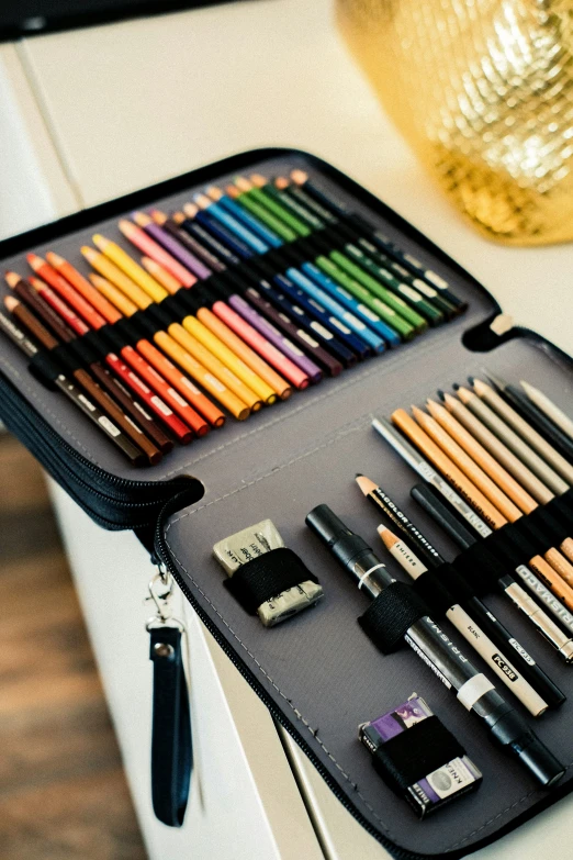 an open suitcase filled with some very pretty colored pencils