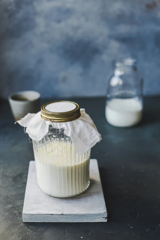 a jar filled with liquid on top of a table