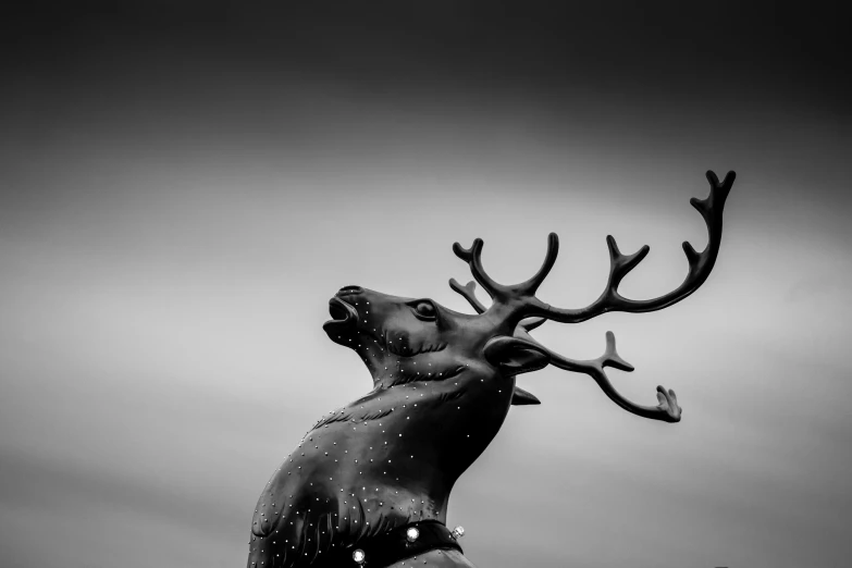 a sculpture of a deer standing and looking up