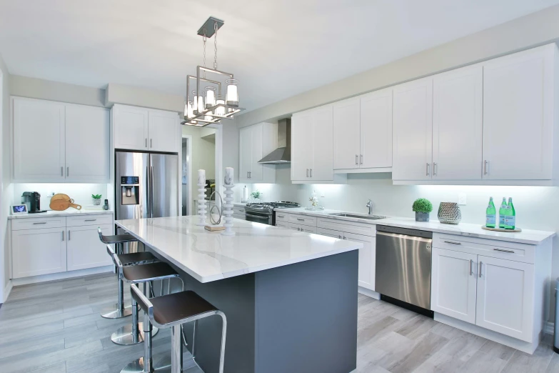 a large kitchen with stainless steel appliances and marble counter tops